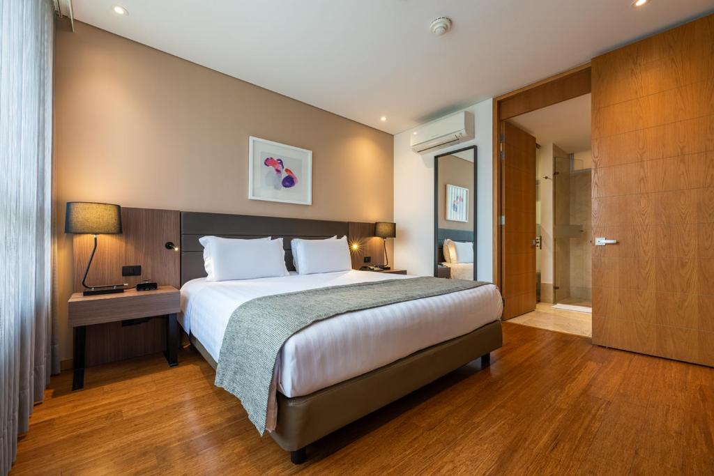 Postel nebo postele na pokoji v ubytování Estelar La Torre Suites