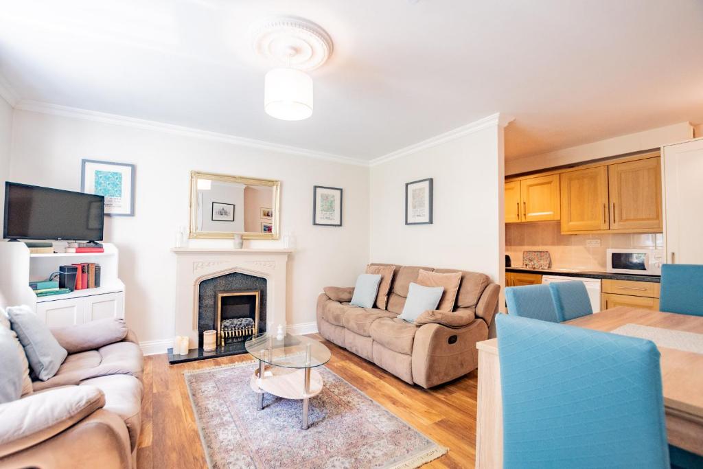 a living room with two couches and a fireplace at City Townhouse with parking in Galway