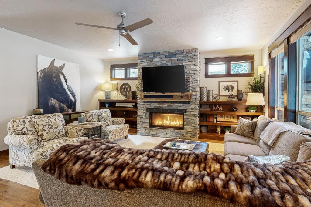 een woonkamer met een bank en een open haard bij Peaceful Peaks Hideout in McCall