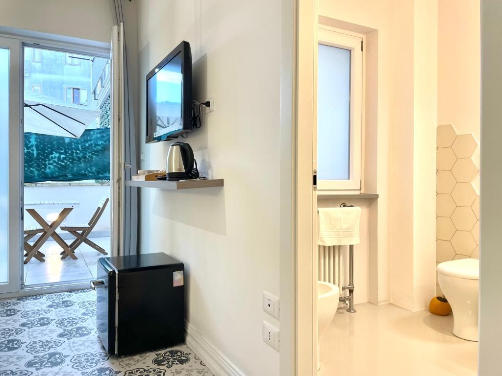TV a/nebo společenská místnost v ubytování Le porte di Lecce Suites