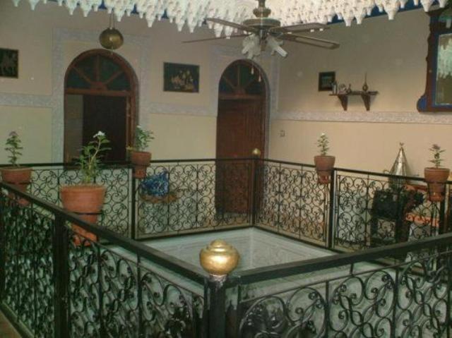 a room with a balcony with a ceiling fan at Riad Karmel Rose de Marrakech in Marrakesh