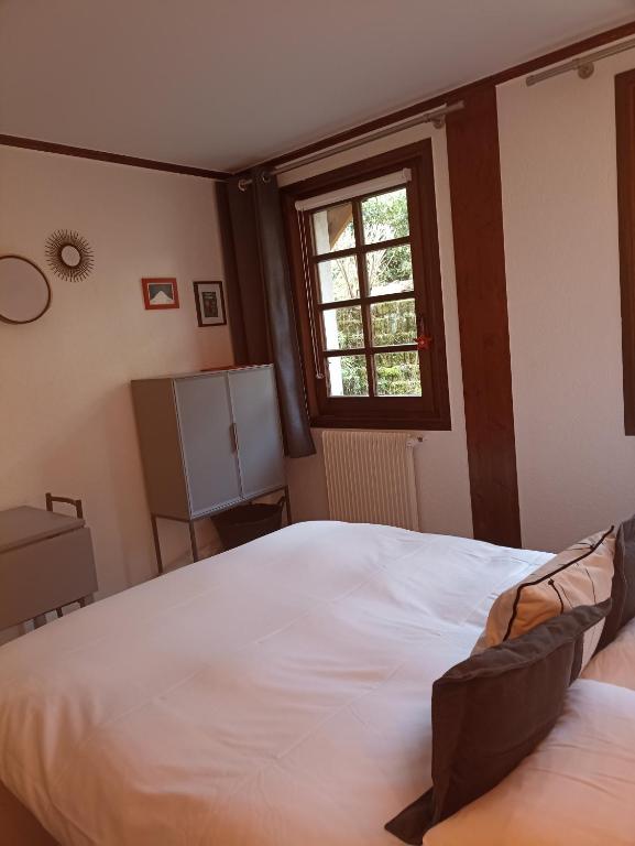 Voodi või voodid majutusasutuse Chalet Appart'Hôtel l'Eau Vive toas