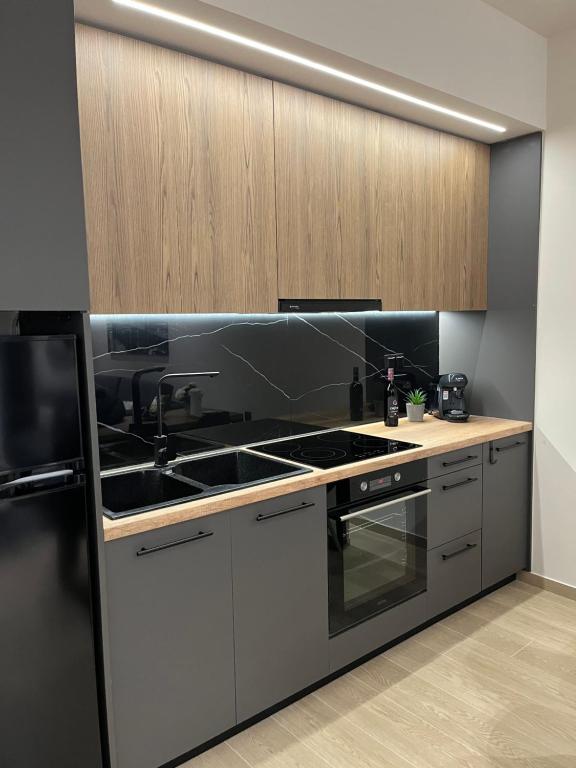 a kitchen with a sink and a stove at Serenity Luxury Apartment in Alexandroupoli