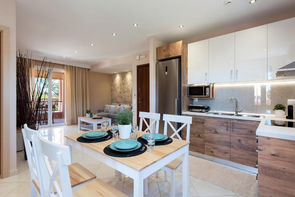 a kitchen and dining room with a table and chairs at Lia's Home One in Mantoúkion