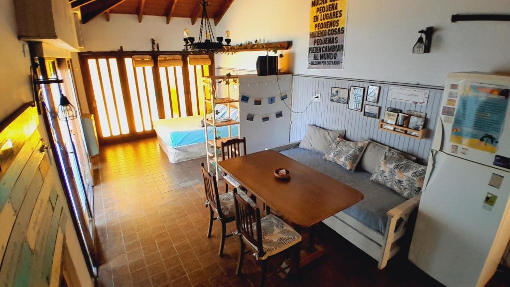 a kitchen with a couch and a table and a refrigerator at Quincholoftmdq monoambiente con cochera in Mar del Plata