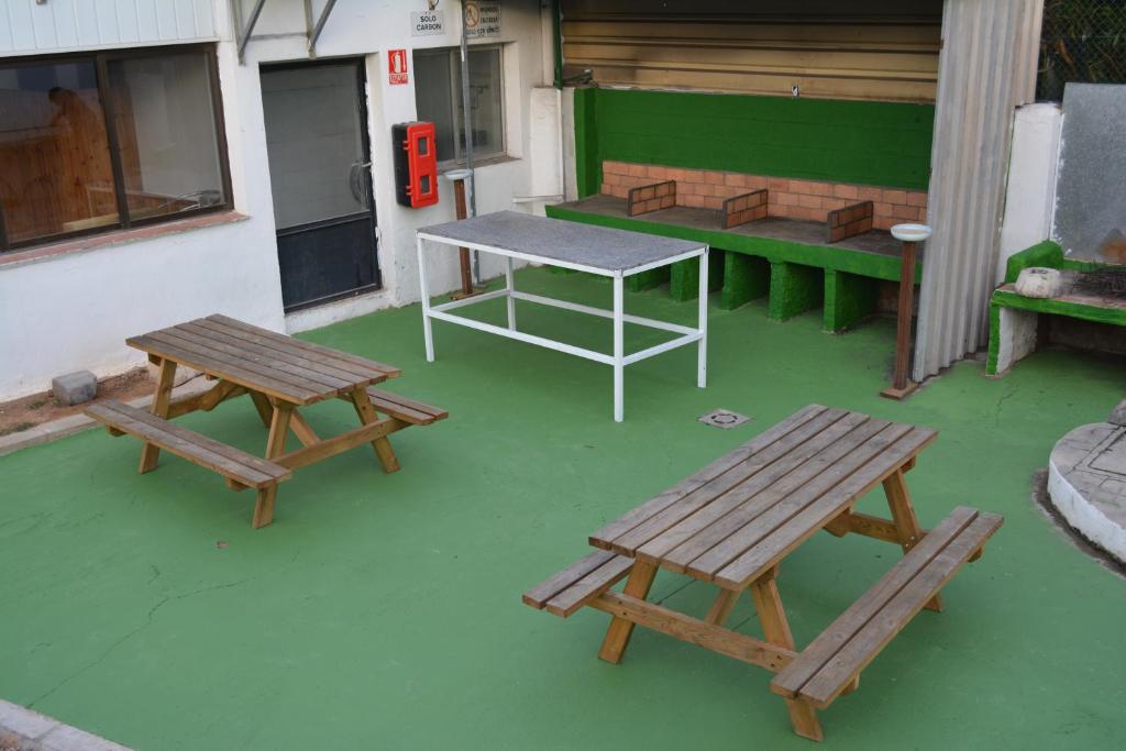 a group of picnic tables and benches on a patio at Camping Valencia el Saler in El Saler