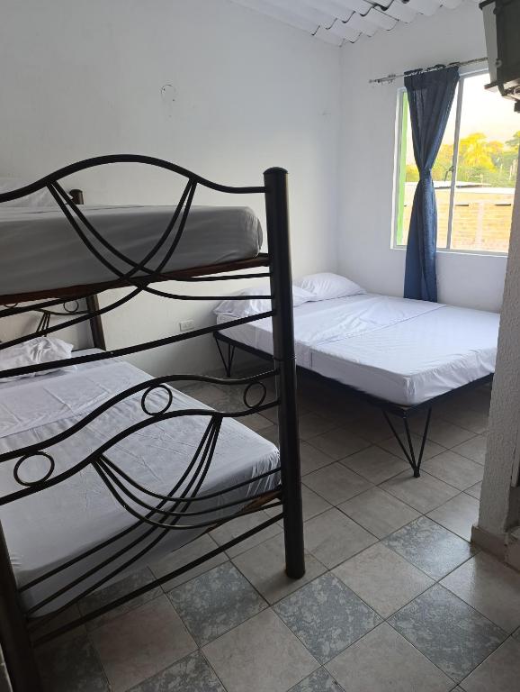 Postel nebo postele na pokoji v ubytování Hotel Mariu Melgar