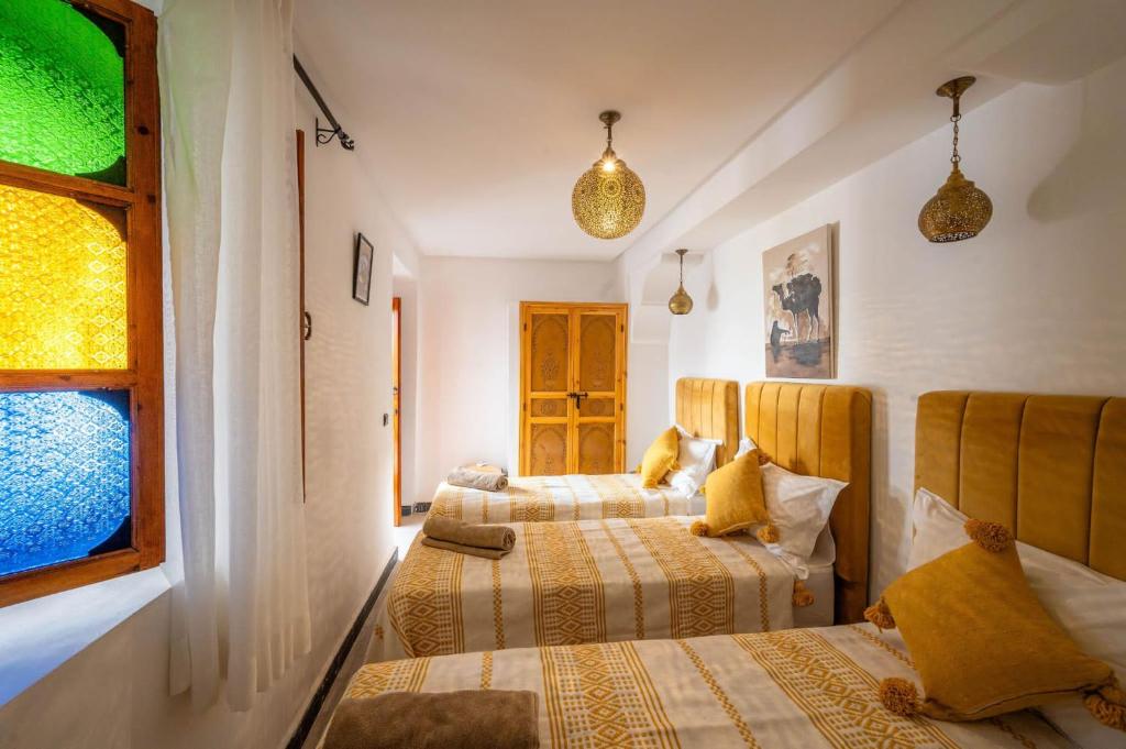 Postel nebo postele na pokoji v ubytování Riad Orient Palace