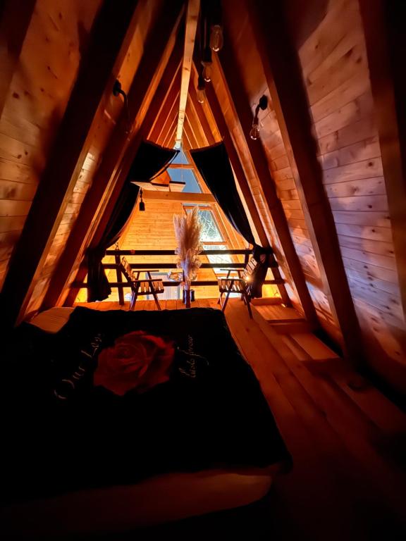 an attic room with a bed and a window at Villa Leka in Siničane
