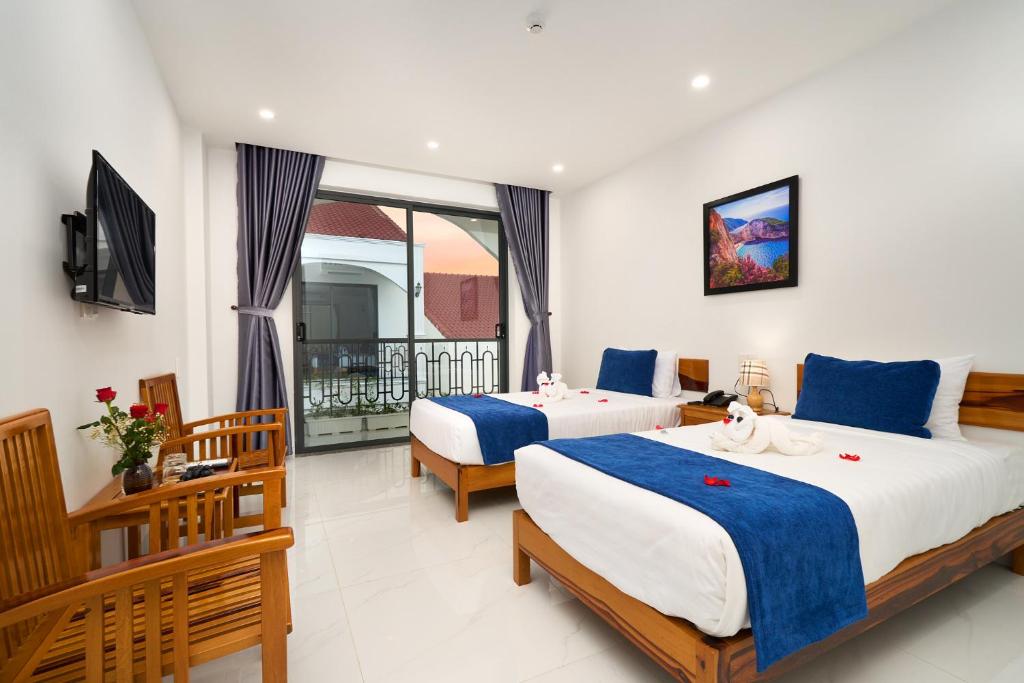 Postel nebo postele na pokoji v ubytování Hoi An Legend Charm Boutique Hoi An Hotel