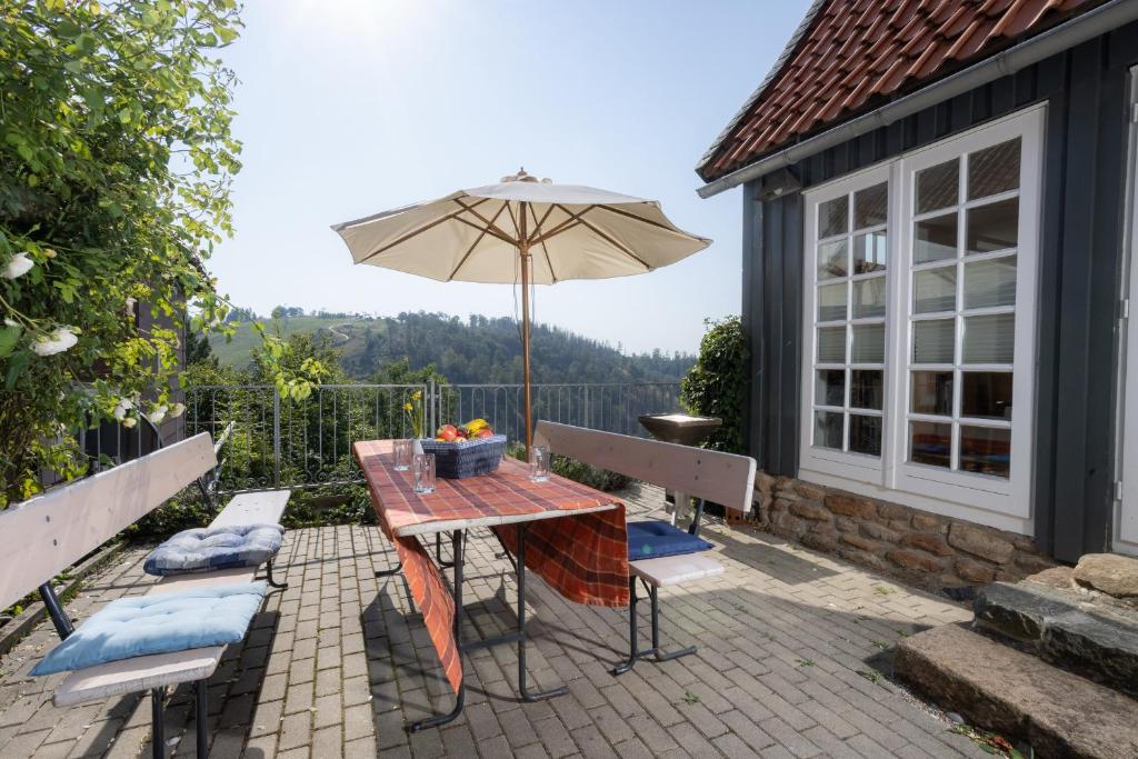 a table with an umbrella on a patio at Ferienhaus am Glockenberg in Sankt Andreasberg