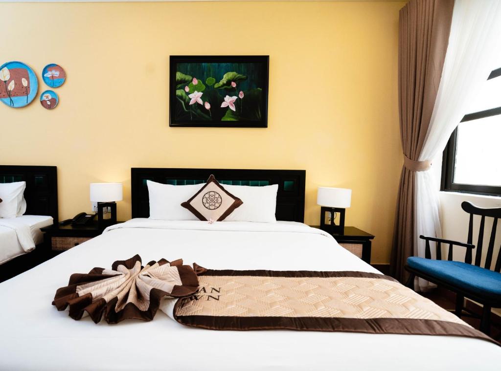 Postel nebo postele na pokoji v ubytování Nature Resort Hoi An By K D H