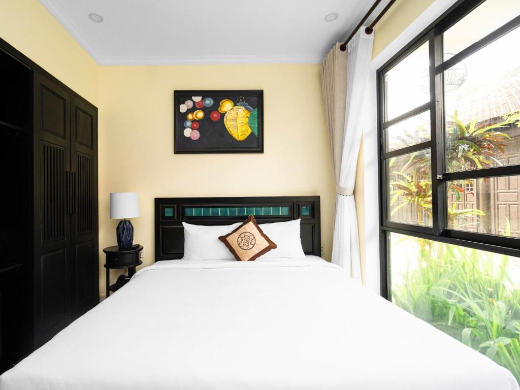 Postel nebo postele na pokoji v ubytování Nature Resort Hoi An By K D H