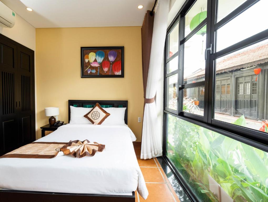 Postel nebo postele na pokoji v ubytování Nature Resort Hoi An By K D H
