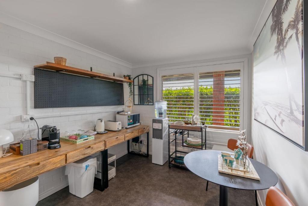 a kitchen with a counter and a table in a room at Kiama Mountain Views Studio in Kiama
