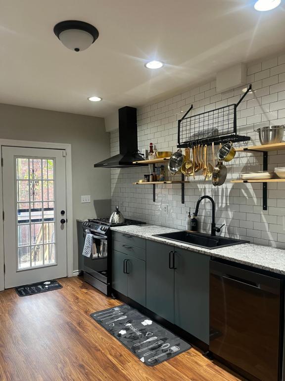 a kitchen with a sink and a counter top at Stylish Townhouse by Carrol Park, M&T Bank Stadium in Baltimore