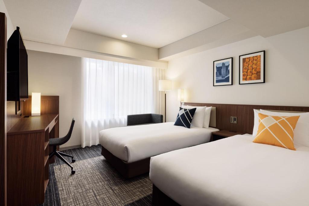 Postel nebo postele na pokoji v ubytování Four Points Flex by Sheraton Kyoto Oike