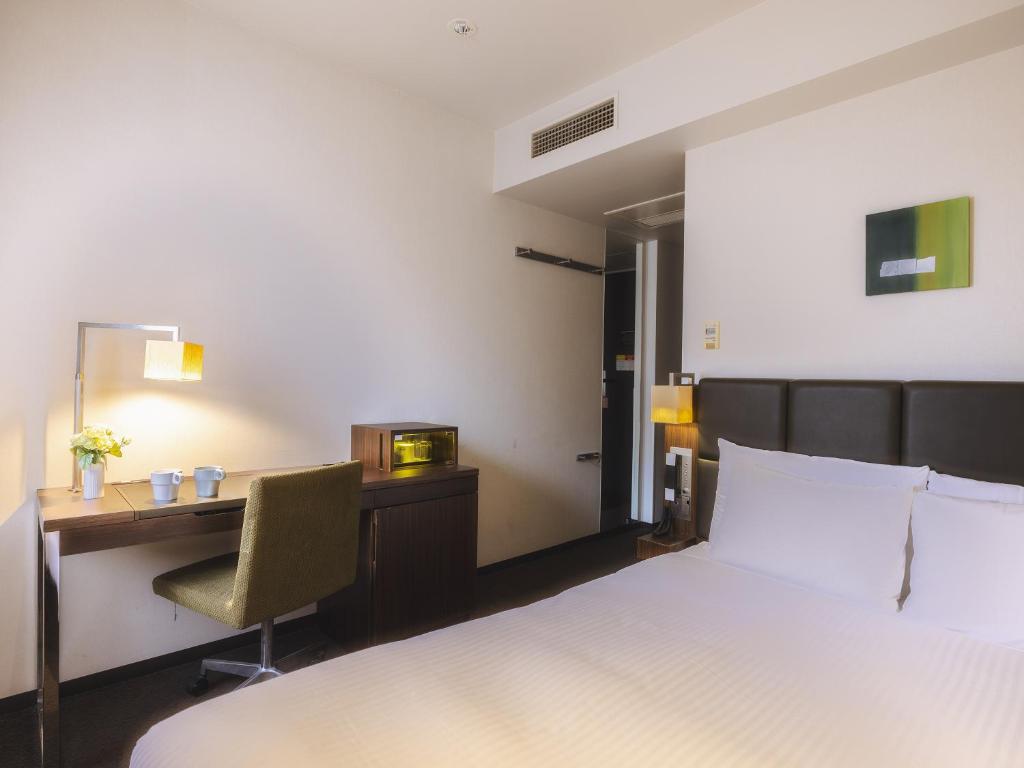 Postel nebo postele na pokoji v ubytování Hotel Gracery Tokyo Tamachi