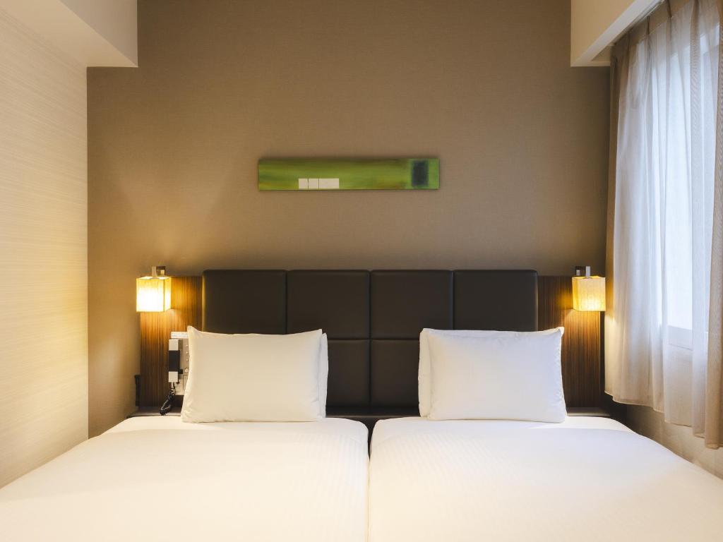 Postel nebo postele na pokoji v ubytování Hotel Gracery Tokyo Tamachi