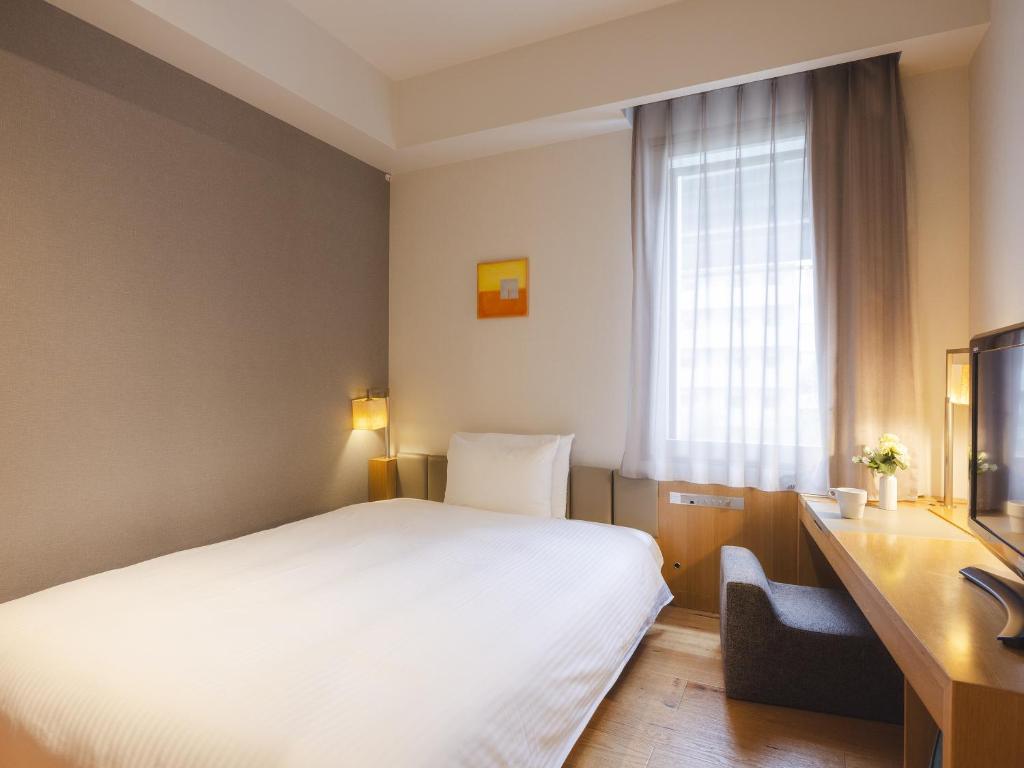 Postel nebo postele na pokoji v ubytování Hotel Gracery Tokyo Tamachi