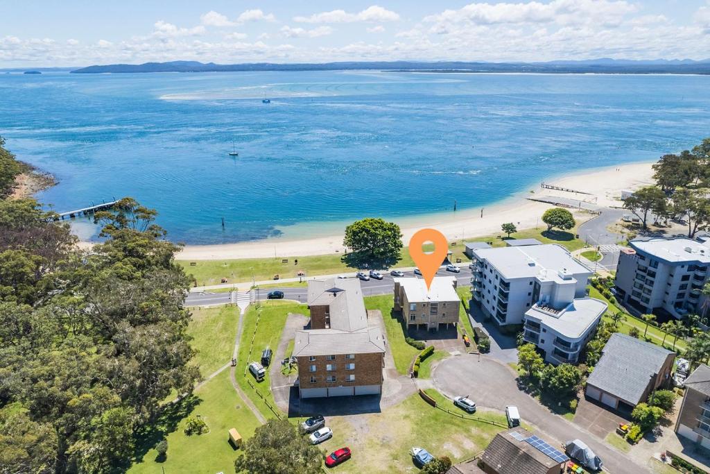 an aerial view of a beach with buildings and a orange marker at Little Hut 1 Spectacular Water Views NBN and Air Conditioned in Nelson Bay