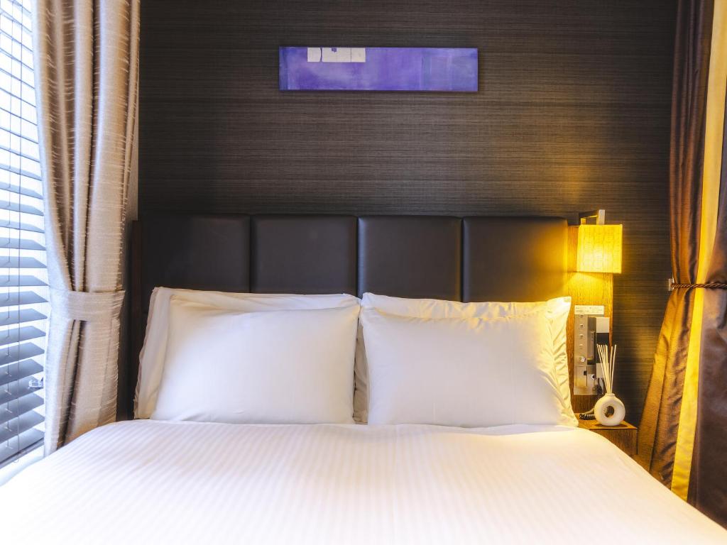 Postel nebo postele na pokoji v ubytování Hotel Gracery Tokyo Tamachi
