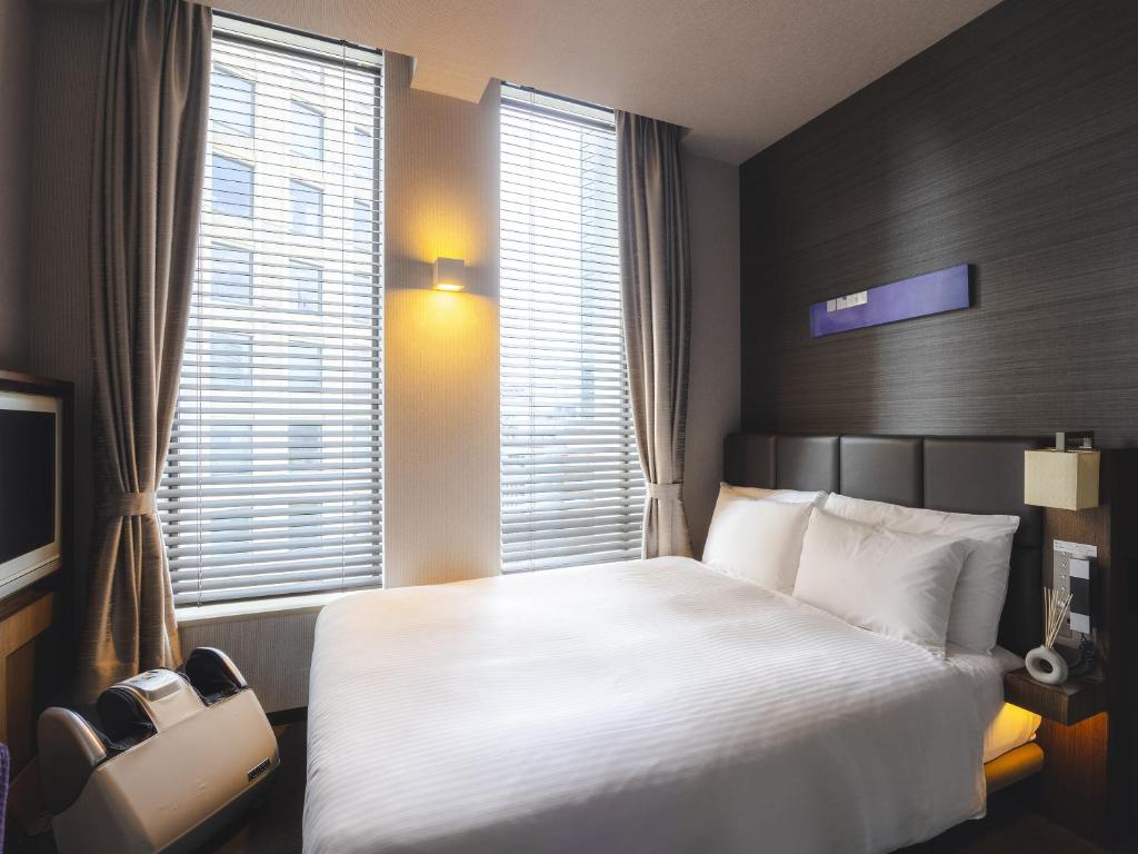 Postel nebo postele na pokoji v ubytování Hotel Gracery Tokyo Tamachi