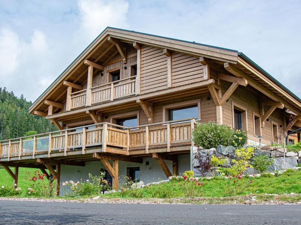 a wooden house with a balcony on the side of it at Chalet grand confort avec sauna et balnéo - Proche stations de ski - FR-1-589-762 in Xonrupt-Longemer