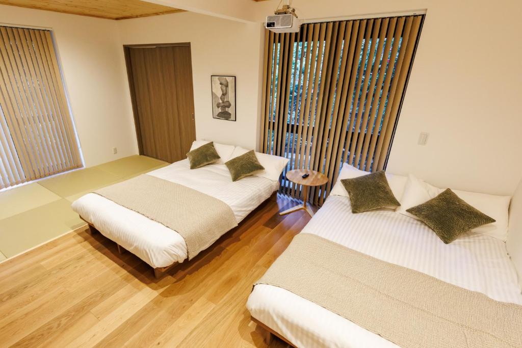 Postel nebo postele na pokoji v ubytování STAY&GO Aso Kurokawa