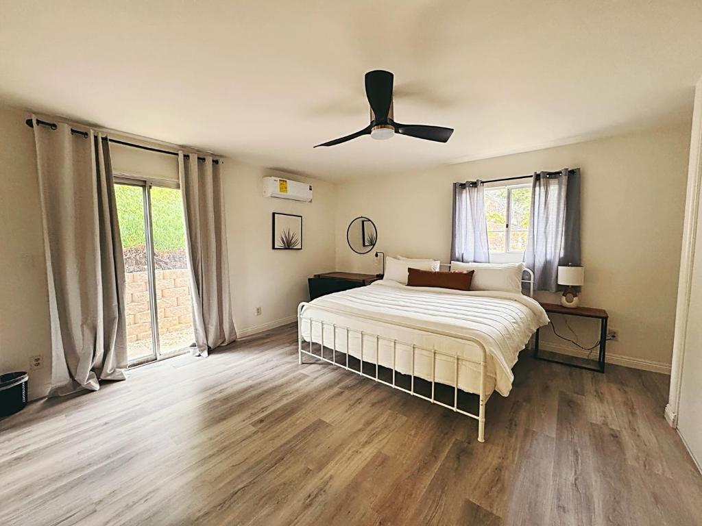 a bedroom with a bed and a ceiling fan at Pet friendly Spacious 3Bed with HUGE Back Yard in San Diego