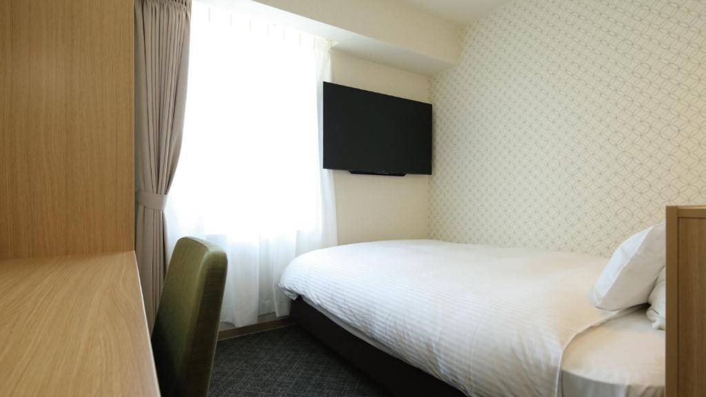 Postel nebo postele na pokoji v ubytování AB Hotel Sakaihigashi