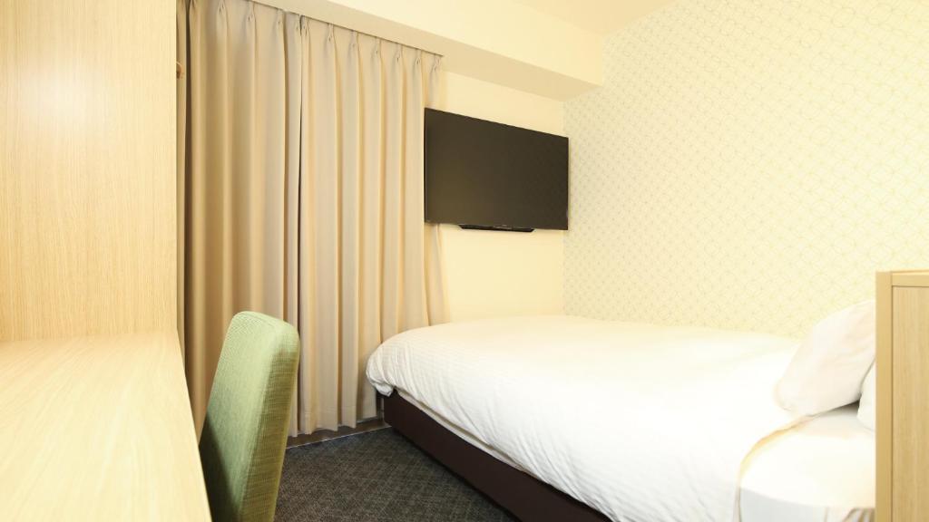 Postel nebo postele na pokoji v ubytování AB Hotel Sakaihigashi