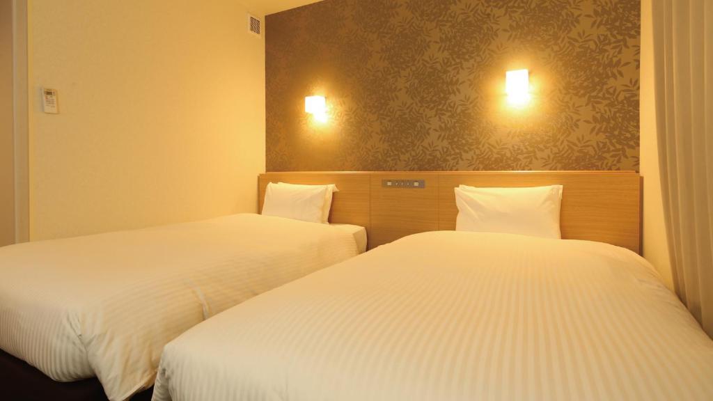 Postel nebo postele na pokoji v ubytování AB Hotel Sakaihigashi