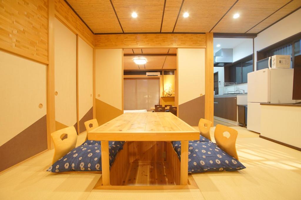 a wooden table and chairs in a room at 伏見稲荷の宿-Inari no Yado- in Kyoto