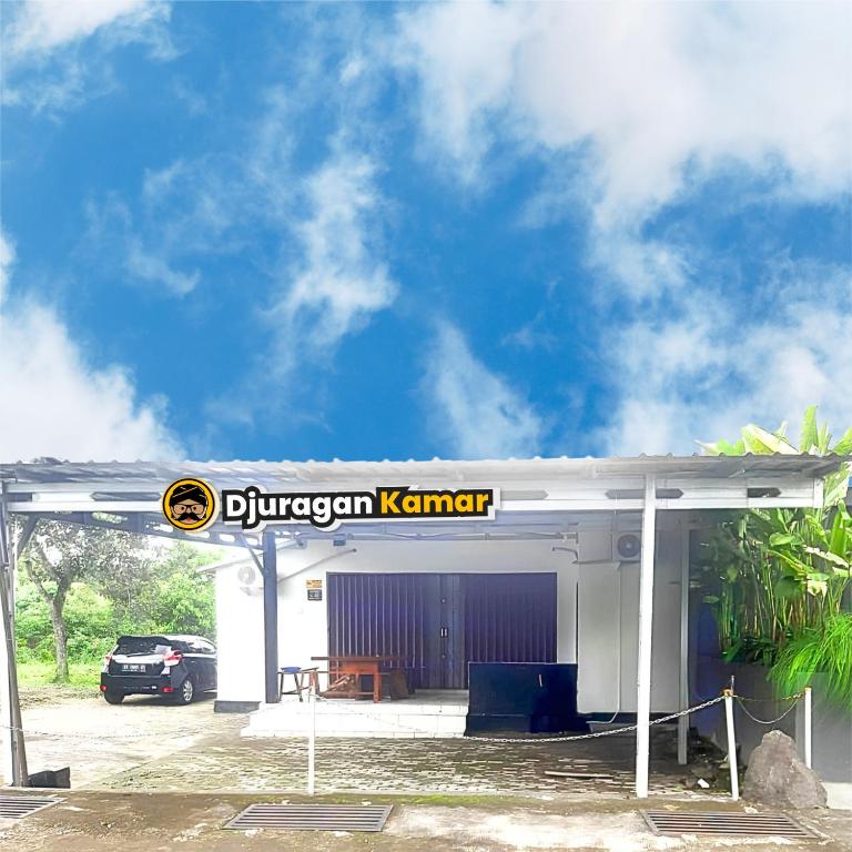 a car parked in front of a hydrogen petrol station at Djuragan Kamar Halona in Ngemplak