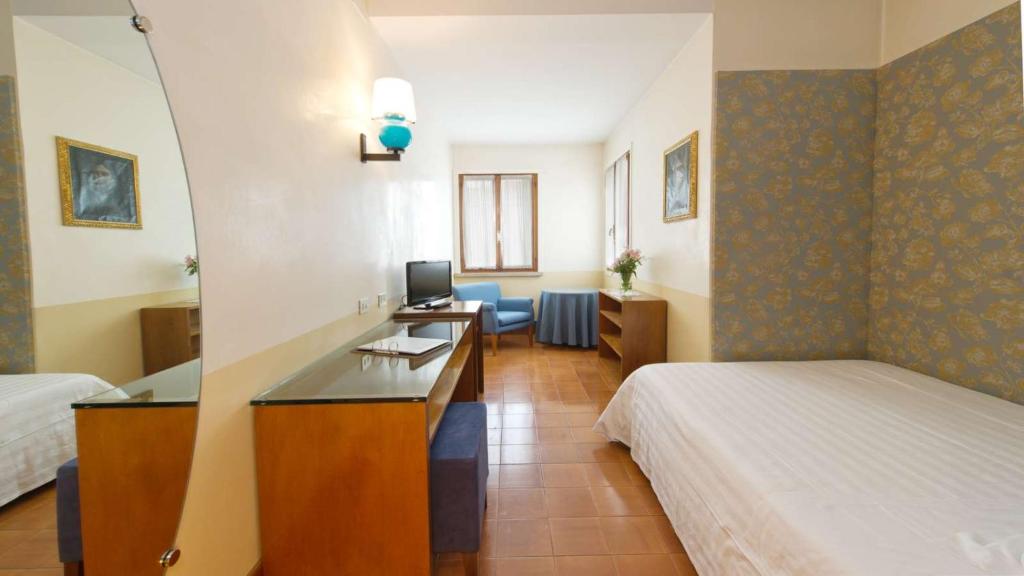 Postel nebo postele na pokoji v ubytování Hotel Villa Mabapa