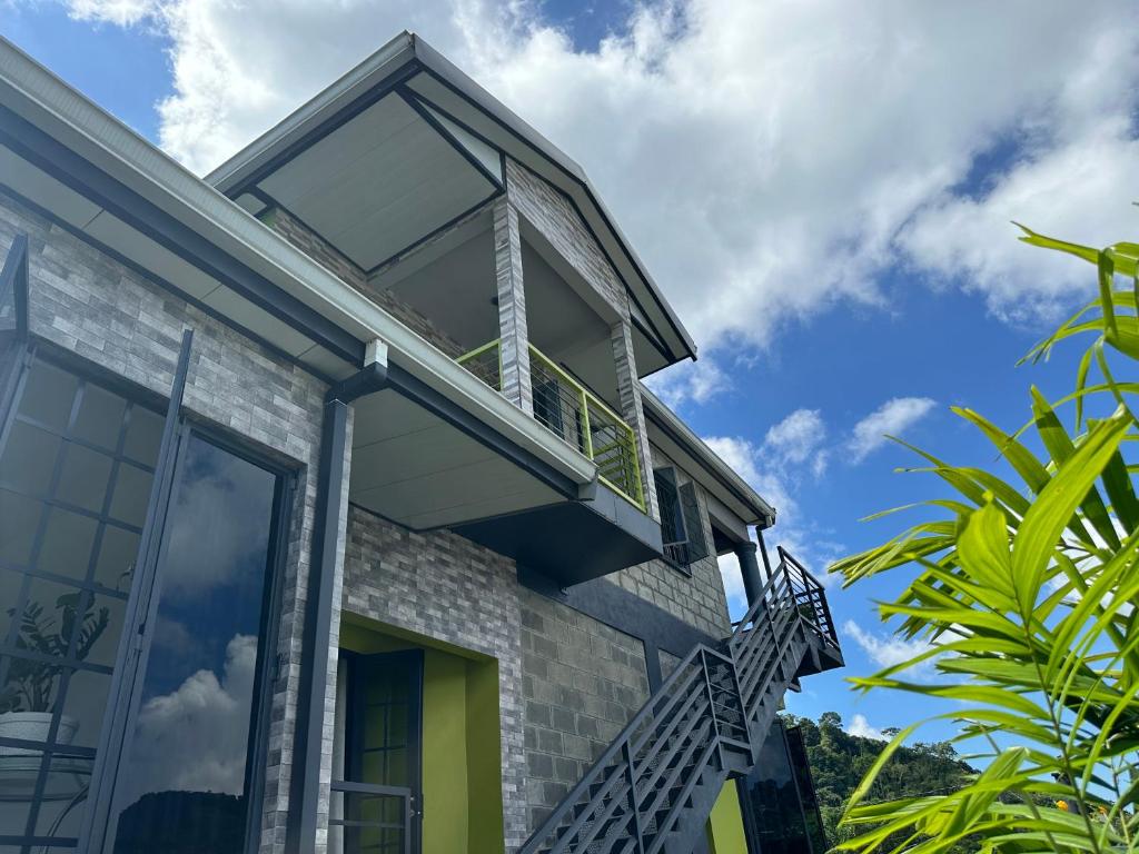 a house with a balcony on top of it at Villa Nola in Port-of-Spain
