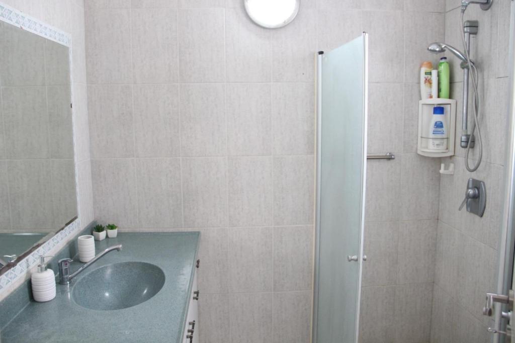 a bathroom with a sink and a shower at ספרינג in Qiryat Shemona