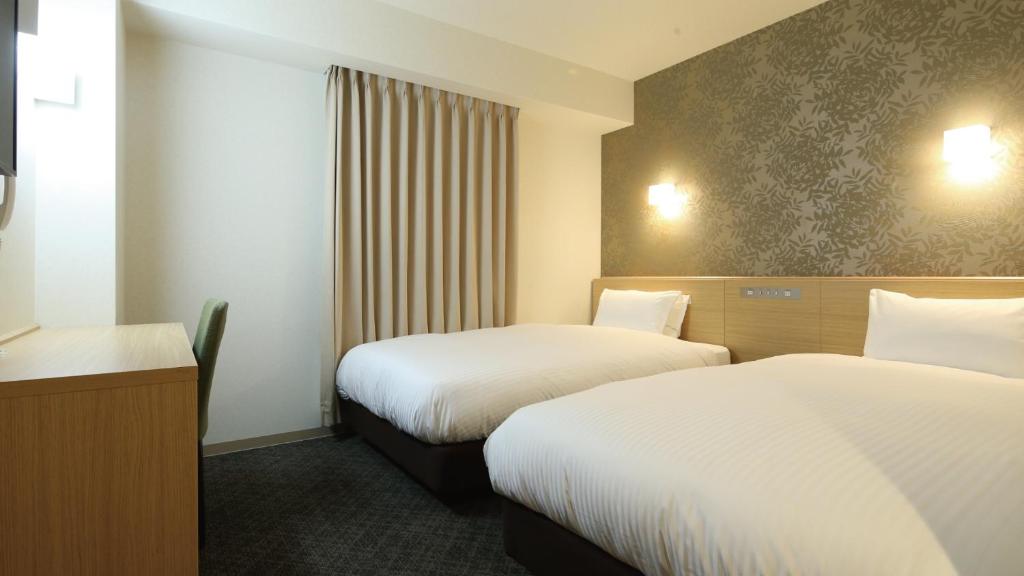 Postel nebo postele na pokoji v ubytování AB Hotel Sakaihigashi