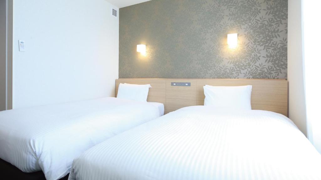 Postel nebo postele na pokoji v ubytování AB Hotel Sakaihigashi