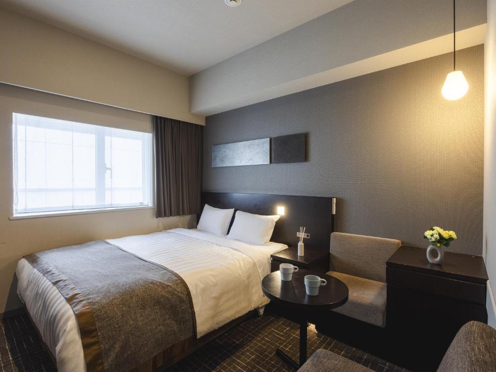 Postel nebo postele na pokoji v ubytování Hiroshima Washington Hotel