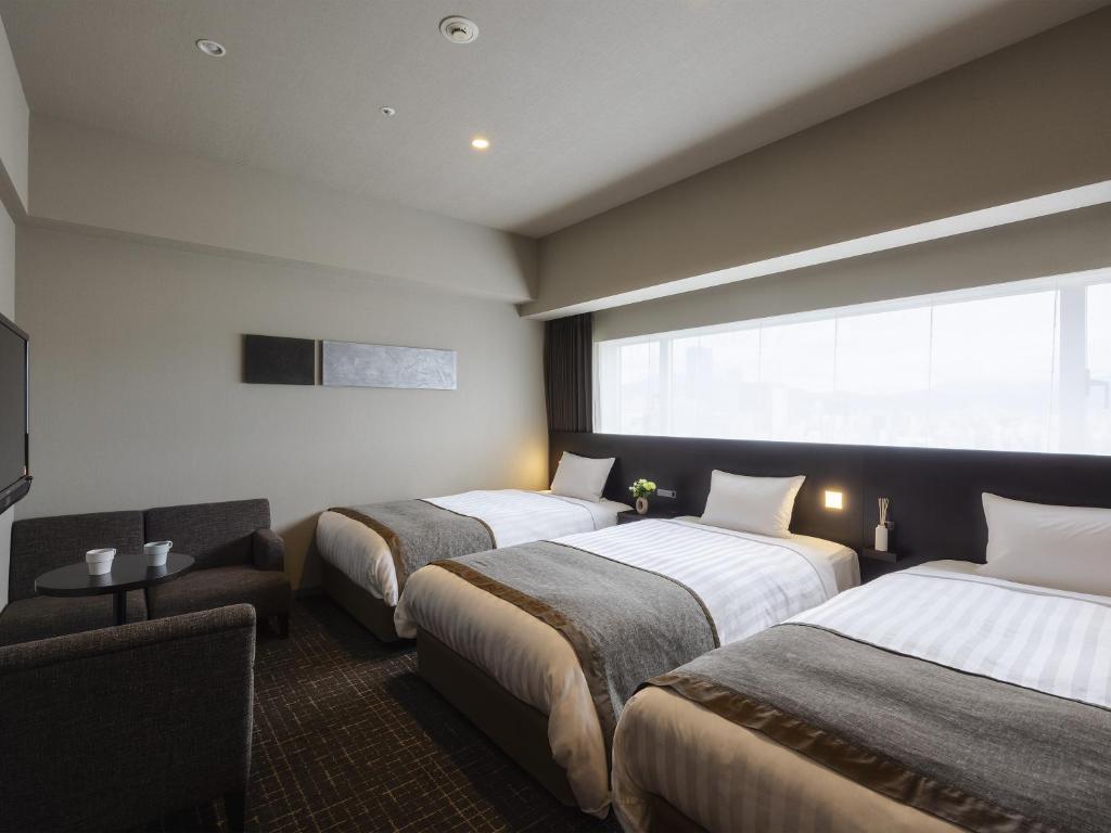 Postel nebo postele na pokoji v ubytování Hiroshima Washington Hotel