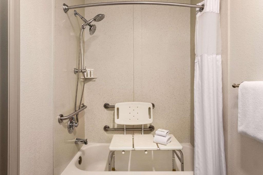 a small bathroom with a white tub and a shower at Radisson Hotel Colorado Springs Airport in Colorado Springs