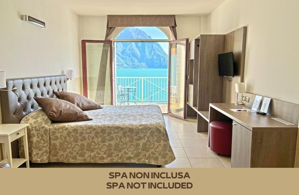 a bedroom with a bed and a large window at Hotel Lovere Resort & Spa in Lovere