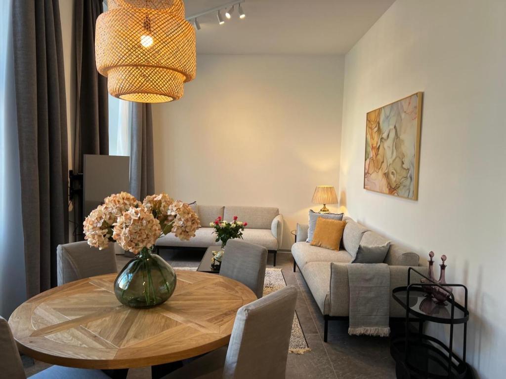 a living room with a table and a couch at Suite Nr 5 - J26 LUXURY APARTHOTEL, Jauniela 26 Old Riga - Great View & Top Location - 2 Bedrooms - 80 m2 in Rīga