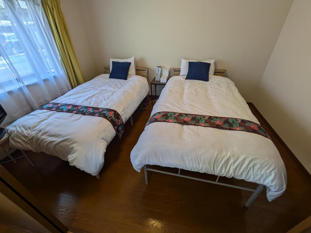 Postel nebo postele na pokoji v ubytování Villa Ishiyamadera ヴィラ 石山寺