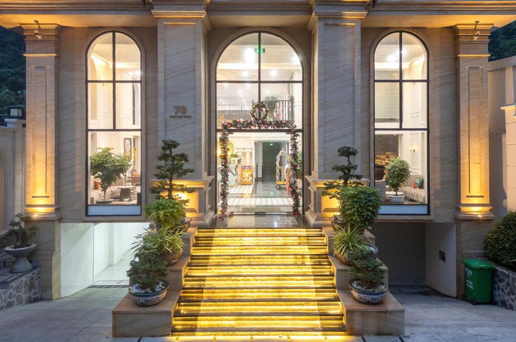 a building with a yellow staircase in front of it at Green LP Hotel & Apartment in Vung Tau
