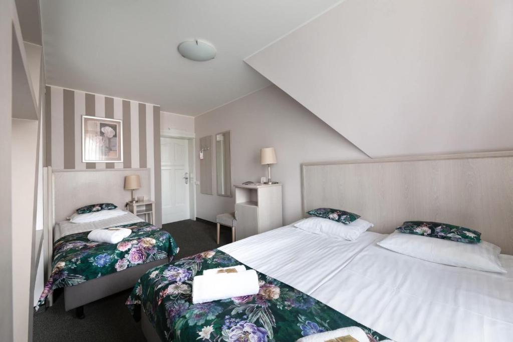 Postel nebo postele na pokoji v ubytování Hotel Amalia