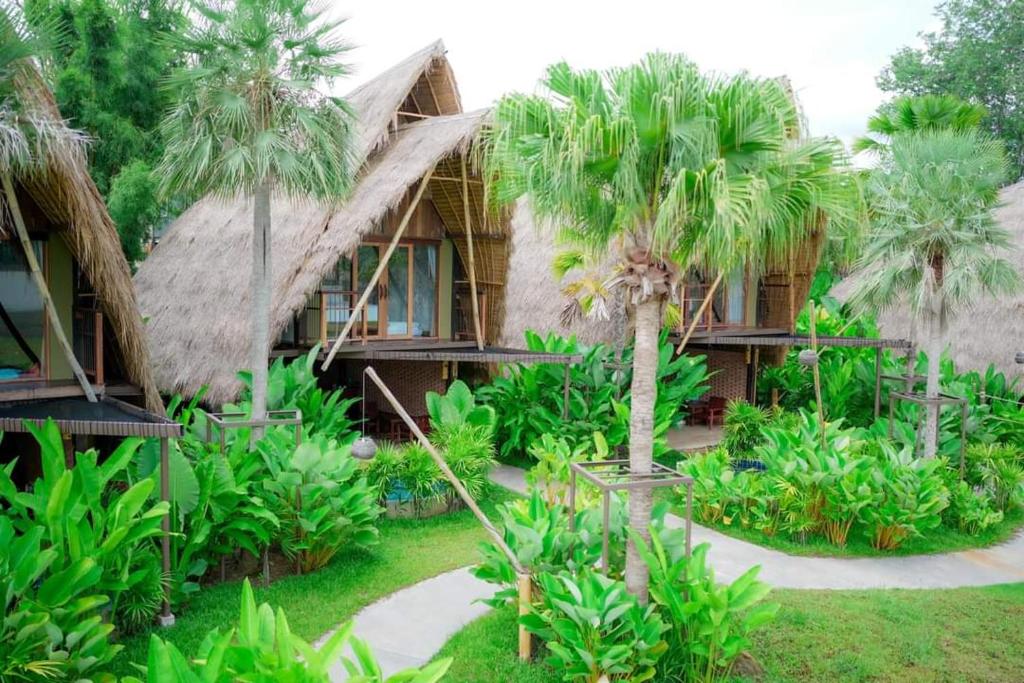 a resort with palm trees in front of it at Earth Elements Eco Resort in Ban Bu Hua Chang