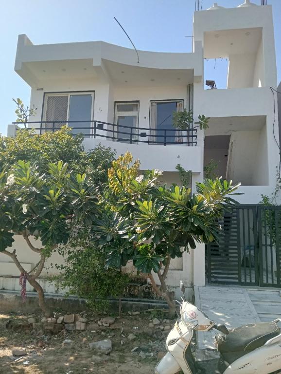 a white motorcycle parked in front of a house at Bagol Niwas in Udaipur